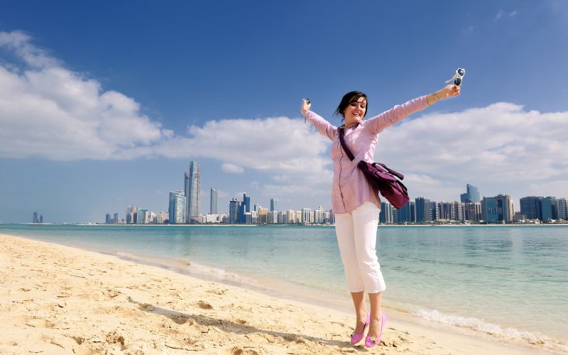 Woman on a Dubai beach wearing a full-sleeve shirt and pants