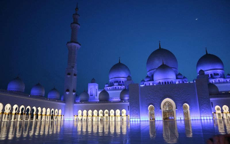 Sheikh Zayed Grand Mosque illuminated at night during Islamic New Year celebrations