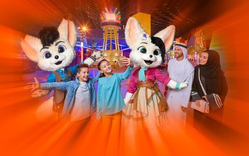 Family taking a selfie with Freddy and Floora at IMG Worlds of Adventure, capturing a fun and memorable moment.