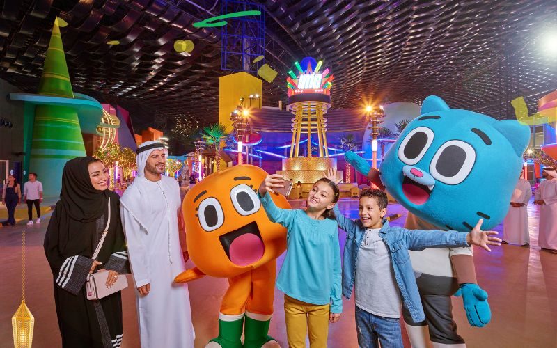 Kids taking a selfie with family and cartoon characters at IMG Worlds during the Ramadan Special, capturing a joyful moment.